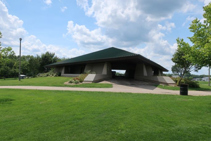 Park shelter with grassy area and path.