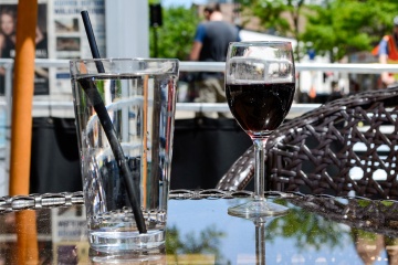 Wine glass and water glass on a table.