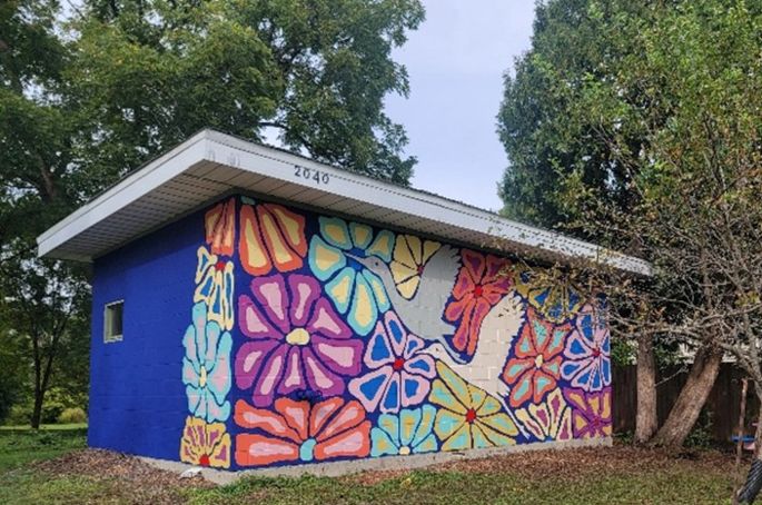 Colorful mural on a building at Harvey E. Schmidt Park