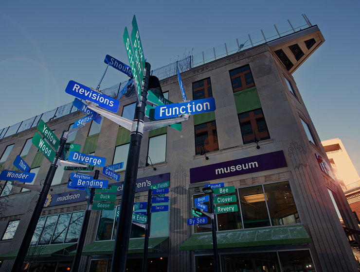 Many road signs pointing in various directions containing clever phrases.