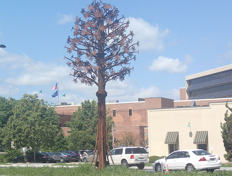 A large metal scupture in the shape of a tree.