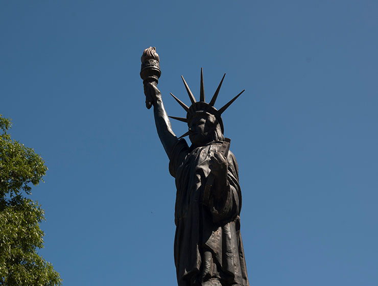 Statue of Liberty set against a blue sky after restoration.