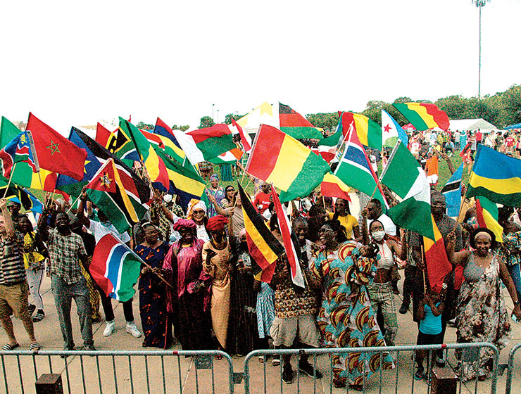 A Group of people with various flags celebrating at AfricaFest 2021