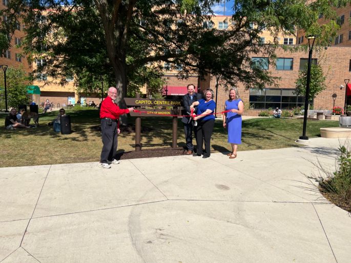 Mayor Satya Rhodes-Conway, Alder Mike Verveer, and others gather for a ribbon-cutting photo