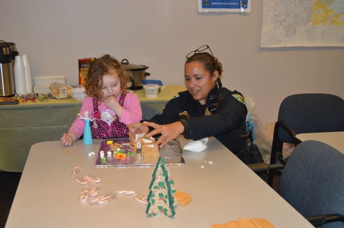 Officer Alex helps with Gingerbread building