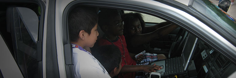 Children exploring a squad car