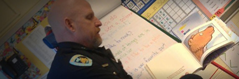 Officer reading a childrens book