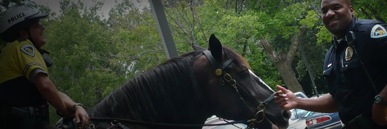 Officer petting a Mounted Patrol horse