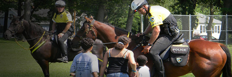 Mounted Patrol officer assisting a family