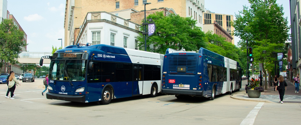 Articulated buses driving down State street. 