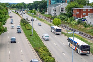 Cars and Metro Transit buses on a busy road.