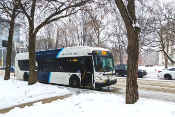 Metro bus stop on a snow-covered road with a marquee displaying 'McKee Route E.
