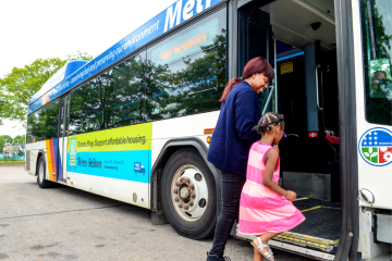 Mother and daughter board a Metro Transit bus.