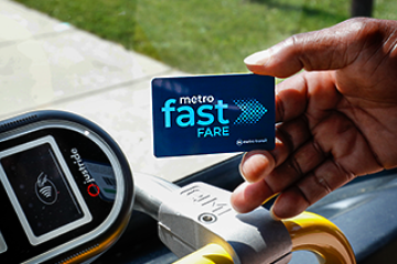 Hand holding a Fast Fare card