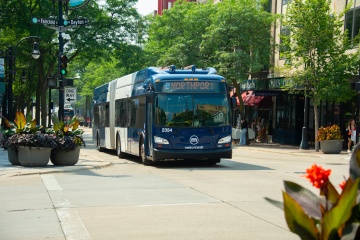 Articulated bus displaying B Northport route travels down State Street on a sunny summer day.