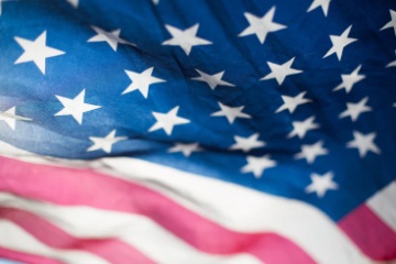 United States flag waving in the wind.