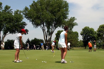 Two golfers on a driving range at Yahara Hills Golf Course