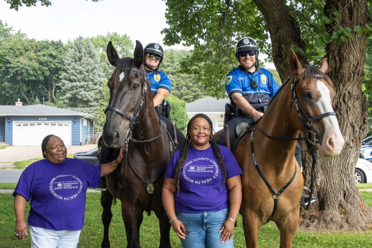 Mounted Patrol Unit poses with community members at National Night Out celebration.