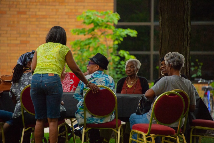 Older adults sit at table at celebration. 