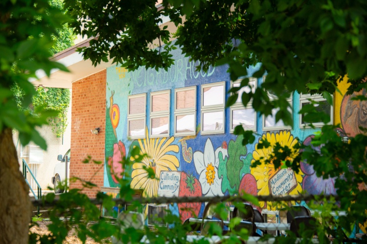 Community center facade with colorful mural. 
