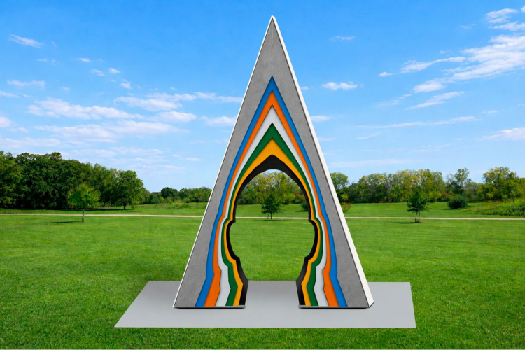 A triangular sculpture with a silhouette of a person's head in the center with a multi-colored outline.
