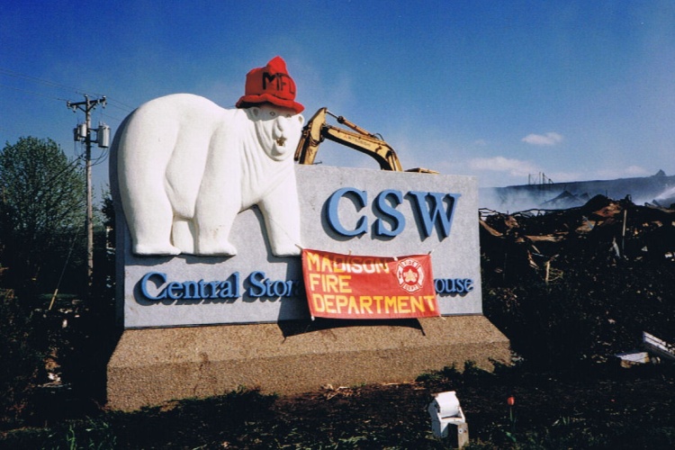 Central Storage Warehouse polar bear sign adorned with a fire helmet and Madison Fire Department banner