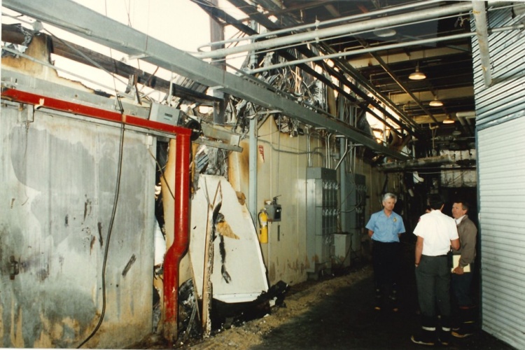 Three people stand in the hallway of Freezer 3