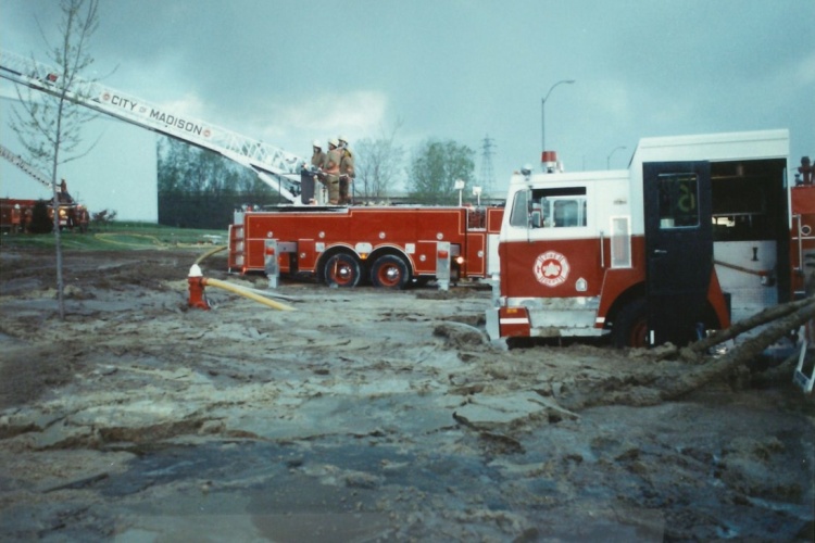 Ladder truck with sludge surrounding it