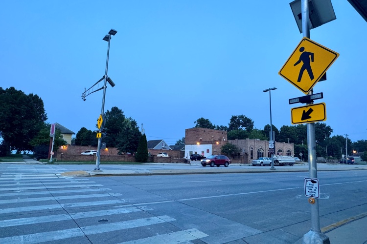 Rectangular Rapid Flashing Beacons (RRFBs) paired with pedestrian crossing signs create a safer environment to cross a busy street at Drake and Park.