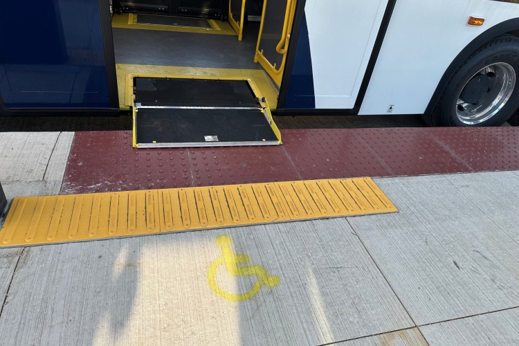 Brown/maroon tactile warning field and yellow raised guide with bus bridge for gap from station platform to bus