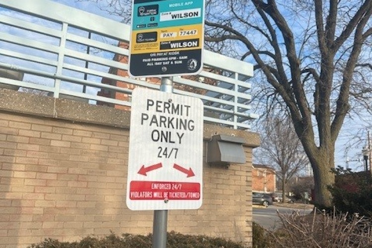 sign showing which spaces are available in the Wilson Lot for nighttime (after 6pm) and weekend public parking.