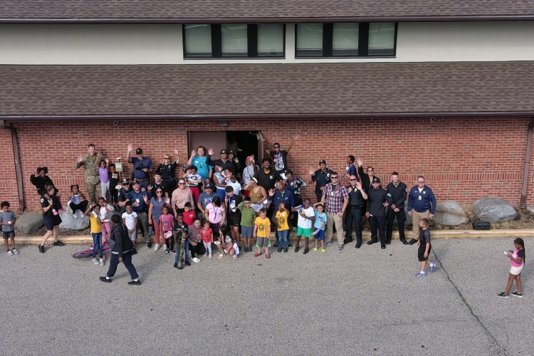 Photo taken with the Unmanned Aircraft System of officers and community members