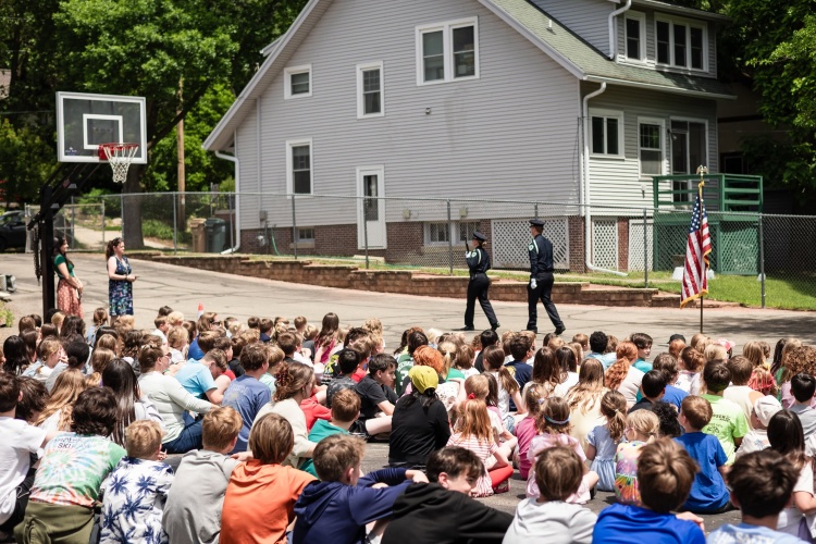 Buckets earns his badge at a ceremony in front of students in Madison.