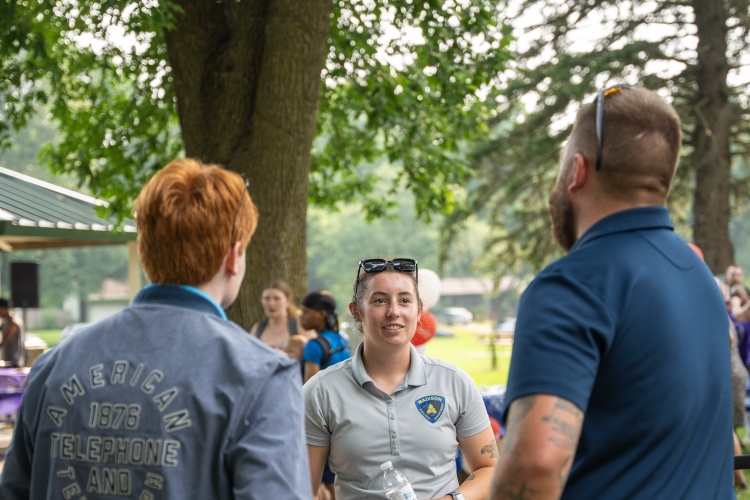 Officer speaks with community members at National Night Out at Meadowood Park