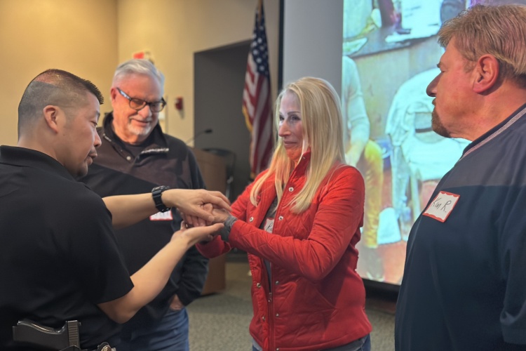 Sergeant Tieu explains to a community member how officers are trained
