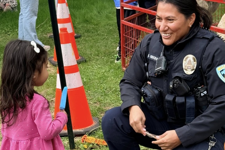 Portrait of Officer Gregorich attending the celebration of a bilingual daycare