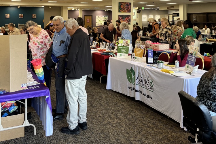 a variety of older people visiting information tables at the 2025 Health Resource Fair