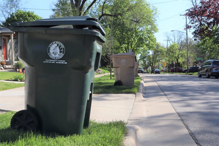 Collection carts along the curb on either side of the driveway