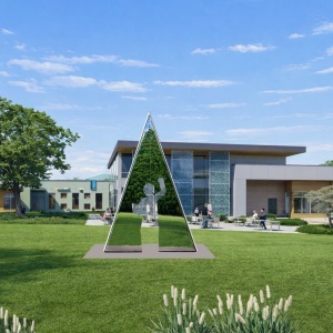 Open larger image in modal - A triangular sculpture with a silhouette of a person in the center. On the front the person is surrounded by a paved road. On the back the mirrored surface reflects the surrounding park.