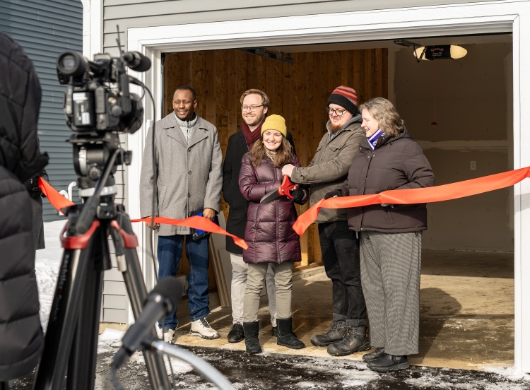 Mayor Satya Rhodes-Conway helps cut the ribbon with two first-time homeowners, Alder Sean O'Brien and local developer Kaba Bah