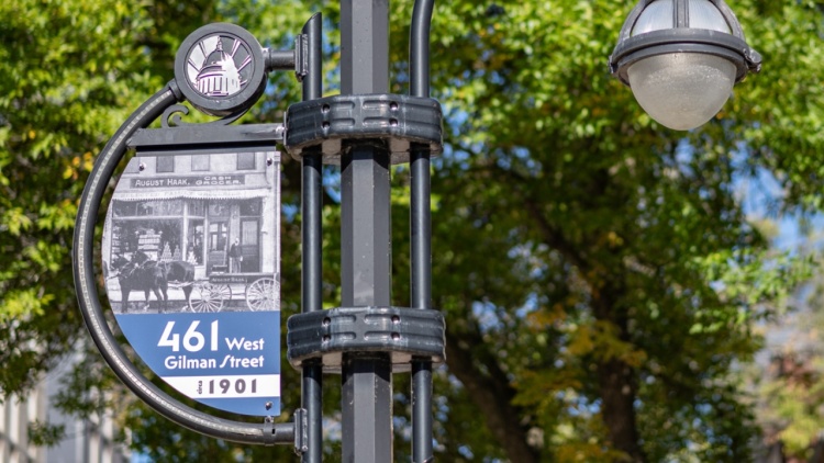 A street banner along Gilman Street showing a historical photo of what was at the since in 1901