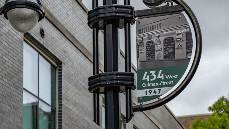 New banners hanging along Gilman Street showing historic photos of the area