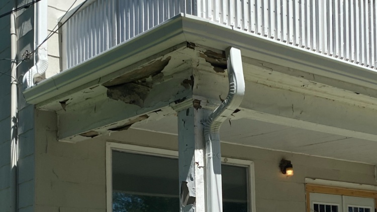 Flaking paint and rotting balcony wood
