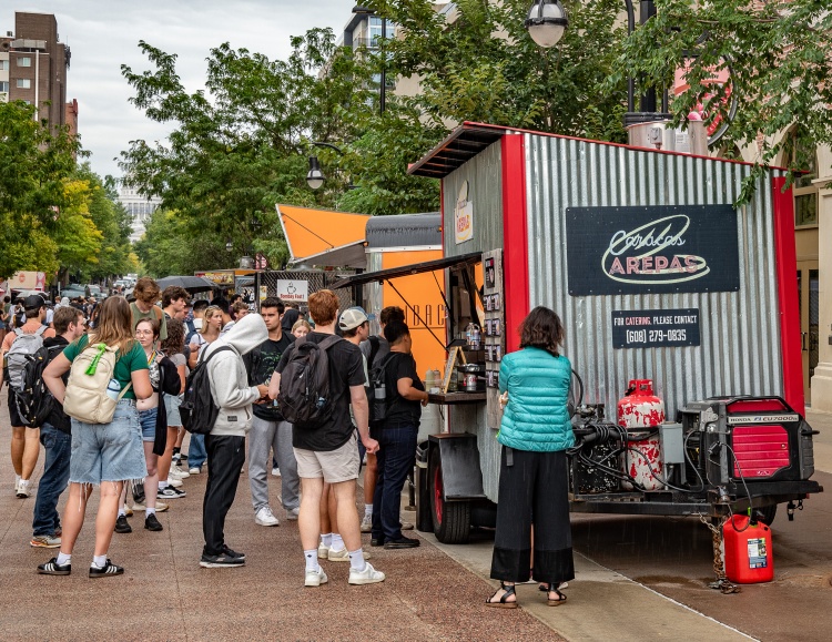 People lined up outside of food carts on the East Campus Mall