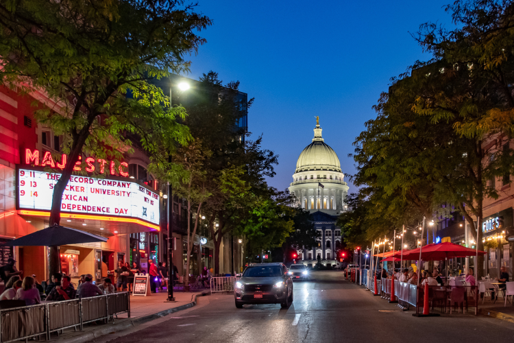 A view down King Street businesses at night with the State Capitol in the background