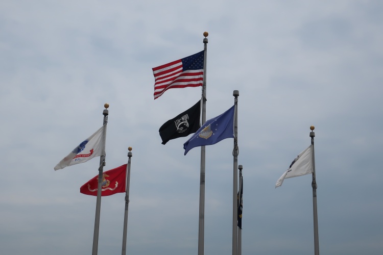 The U.S. flag and the flags of U.S. military branches flying at Veterans Memorial Park in Madison