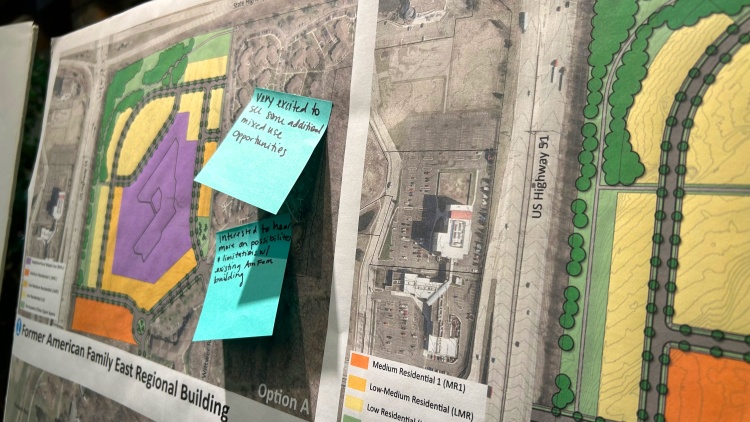 Feedback sticky notes on maps at a community engagement meeting