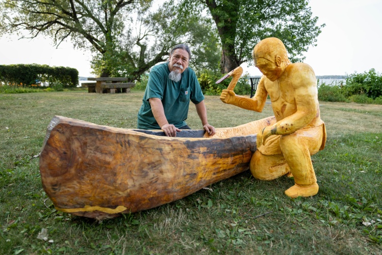 Gene Delcourt standing behind his "Dugout at Merrill Spring" art piece