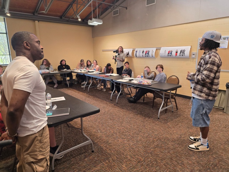 Dr. Faisal Abdu'Allah and Kamari McGee speak to students at the Warner Park Community Recreation Center
