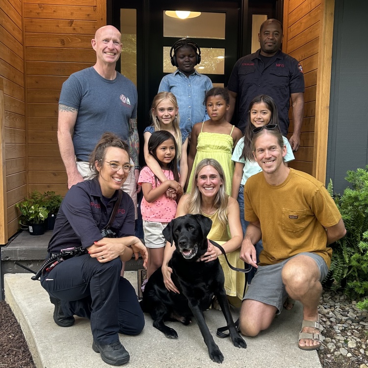 Firefighters gather with the family and Ian on the front doorstep